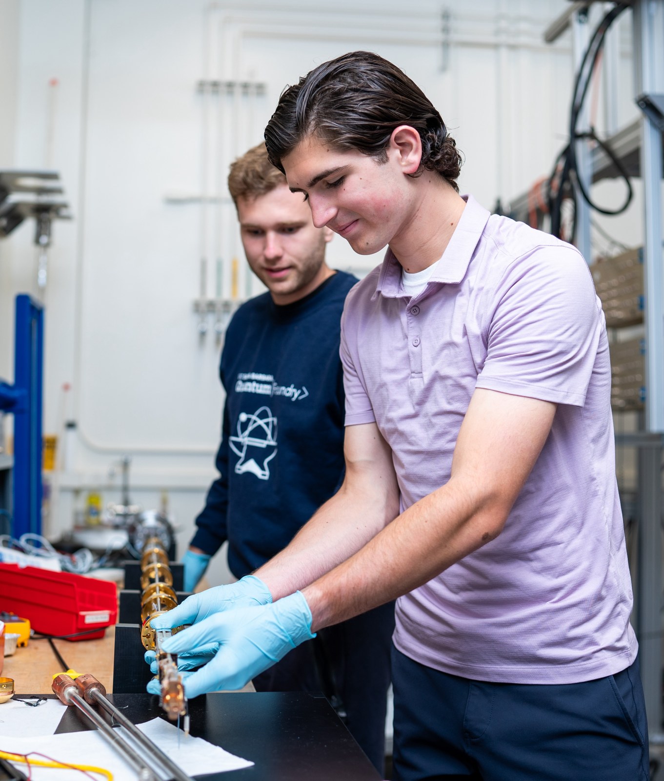 A research student and mentor working at a laboratory bench