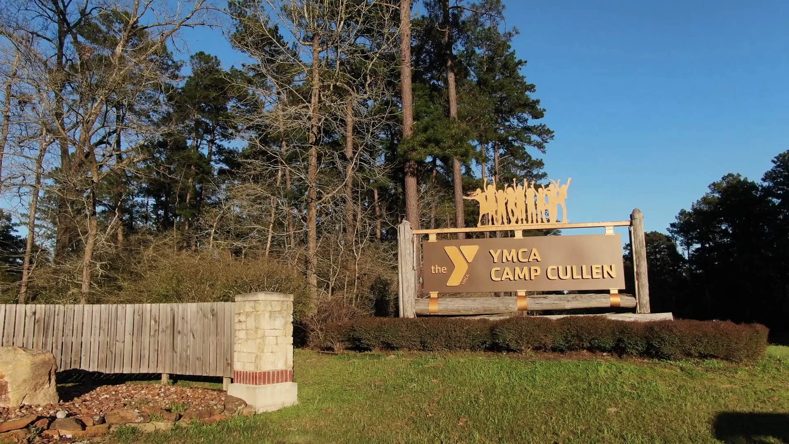 The wooded entrance and sign at YMCA Camp Cullen
